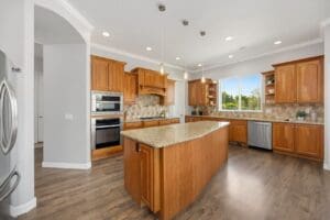 Kitchen with stained wood cabinets, granite island, and hardwood floors in a Santa Rosa, CA home