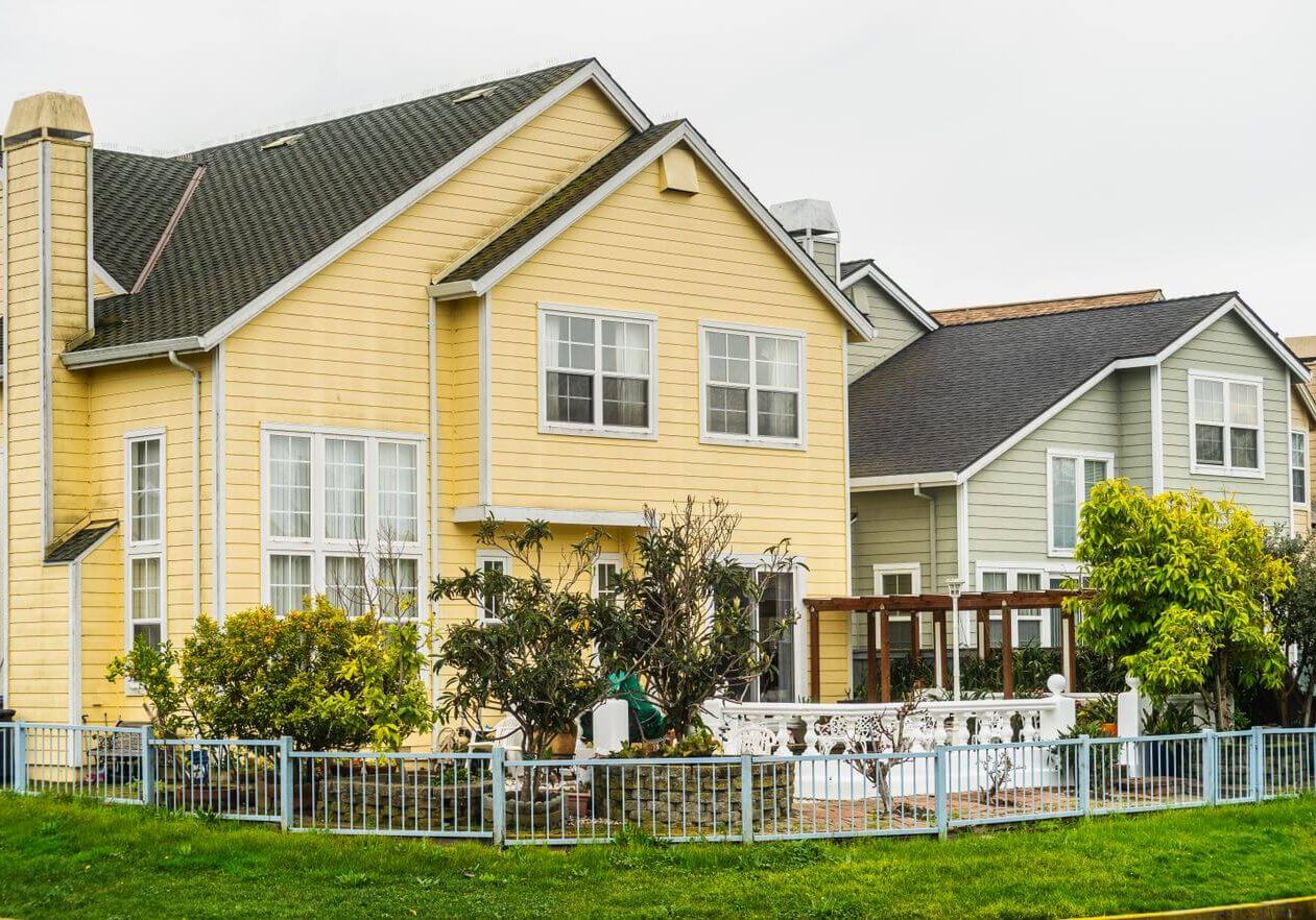 Two-story yellow home with white trim and freshly painted exterior siding in Santa Rosa, CA